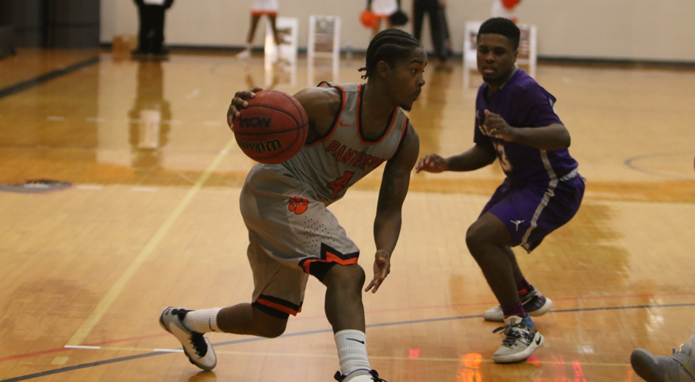 Stevonte Young drives past Fontbonne guard in Saturday's game.